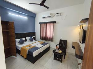 a bedroom with a bed and a television in it at TS-K-MARVELL in Rāmeswaram