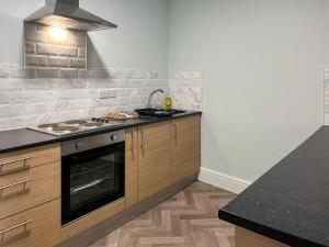 a kitchen with a stove and a counter top at Primrose - Uk49360 in Bridlington