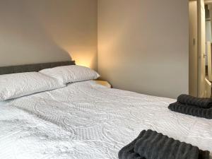 a bedroom with a large white bed with a pillow at Primrose - Uk49360 in Bridlington +11 photos