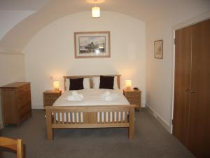 a bedroom with a large bed with two night stands at Moat House 1 - Ukc4887 in Fort Augustus