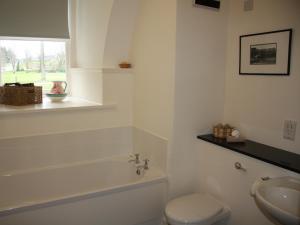a white bathroom with a toilet and a sink at Moat House 1 - Ukc4887 in Fort Augustus +5 photos