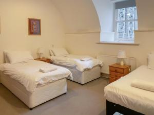 a room with three beds and a window at Moat House 1 - Ukc4887 in Fort Augustus