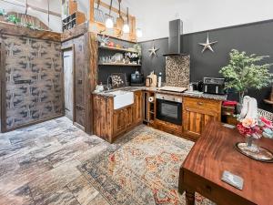 a kitchen with wooden cabinets and a table at Bert's Barn in Firsby