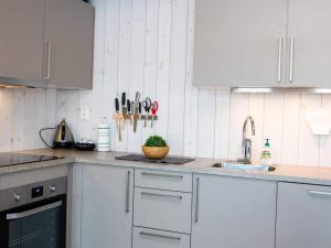 a kitchen with white cabinets and a sink at 4 star holiday home in Øyer in Øyer