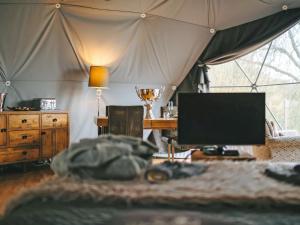 a bedroom with a bed and a tv in a tent at The Star Dome - Ukc6978 in Ludlow