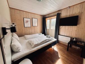 a bedroom with a bed in a room with a window at Lødingen Brygge in Lødingen