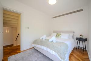 a bedroom with a bed with two towels on it at Carmelo I MOD Villa in Herzliya B +17 photos