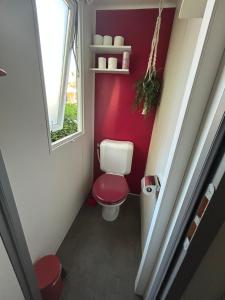 a small bathroom with a toilet and a window at Le SaraLéna in Torreilles