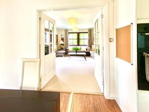 a hallway with a door open to a living room at Lochindaal in Tarbert