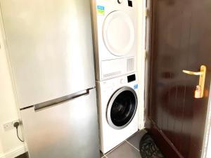 a washer and dryer in a kitchen next to a refrigerator at Lochindaal in Tarbert +16 photos