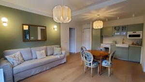 a living room with a couch and a table and chairs at Casa dì in Florence
