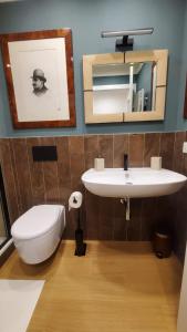 a bathroom with a sink and a toilet and a mirror at Casa dì in Florence