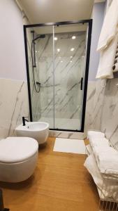 a bathroom with a shower and a toilet and a sink at Casa dì in Florence
