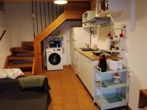 a small kitchen with a refrigerator and a stove at El Mullaero in Aldeanueva del Camino
