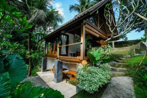 a small house in the middle of a forest at Ubud Jungle Stay - Mahari by WAHM in Ubud