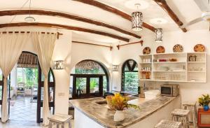 an open kitchen with a large island in a house at Villa Tewa in Mtwapa