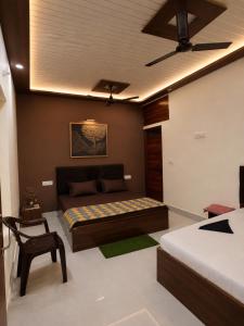 a bedroom with a bed and a ceiling fan at Sudama Palace - Free Temple Pass For Guests in Ayodhya