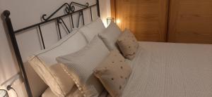 a bedroom with a bed with white pillows at Caldasia in Caldas de Reis