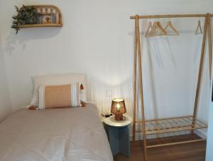 a bedroom with a bed and a lamp on a table at Gaia in Posidhonía