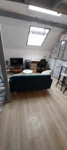 a living room with a couch and a table at Studio Arc en Ciel in Bouguenais
