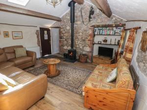 a living room with a couch and a fireplace at Ramsgrove in Swansea