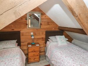 a bedroom with two beds in a attic at Ramsgrove in Swansea