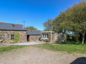 an old stone house with a yard in front of it at Ramsgrove in Swansea