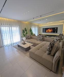 a large living room with a couch and a fireplace at Elite'Stay by Al Amir in Cabo Negro