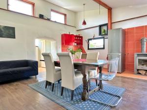 a kitchen and dining room with a table and chairs at Ziggiho chalupa in Pliešovce