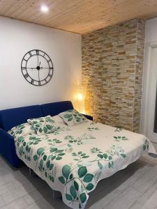 a bedroom with a bed and a clock on the wall at Le Cupe in Corciano +21 photos