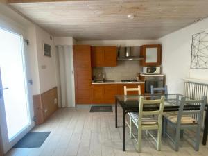 a kitchen with a dining room table and chairs at Le Cupe in Corciano