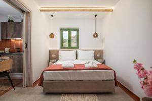 a bedroom with a bed with two towels on it at Aegora Residence in Kalithies +54 photos