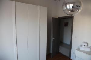 a hallway with white cabinets and a light fixture at Don Giovanni Apartments in Scafati