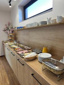 a kitchen with a counter with plates and dishes at Pokoje Hotelowe Wiktoria in Goczałkowice Dolne