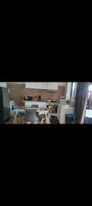 a kitchen with tables and chairs in a room at Fleur de Vanille in Saint-Philippe