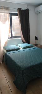 a bed sitting in a bedroom with a window at Fleur de Vanille in Saint-Philippe