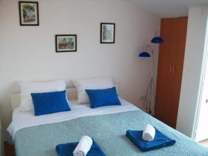 a bedroom with a bed with blue towels on it at Apartment Monika in Rovinj
