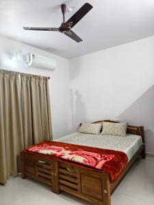 a bedroom with a bed with a ceiling fan at Periyarhills 2 BHK Budget villa Thekkady in Thekkady