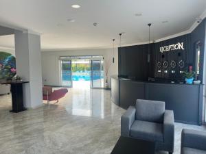 a lobby with a reception desk and a chair at Pera Aura Resort Hotel & Spa - All Inclusive in Kemer