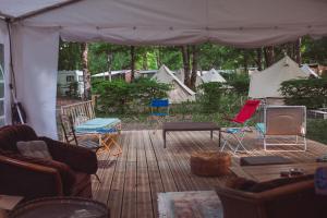 a patio with chairs and a table and a tent at Le Spot Passy in Passy