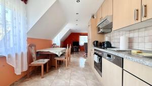 a kitchen with a counter and a table with chairs at Agroturystyka Düsselkamp Tumiany in Barczewo