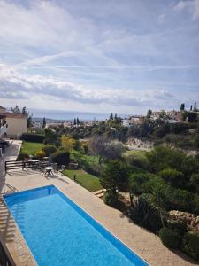 a view of a swimming pool from a house at Sun Set at Coral Bay in Peyia