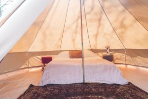 a bedroom with a bed in a tent at Le Spot Passy in Passy