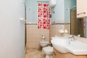 a bathroom with a sink and a toilet at Casa Levante - 3 camere, veranda e vista mare in Stintino +30 photos