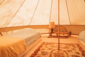 a room with two beds in a tent at Le Spot Passy in Passy