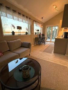 a living room with a couch and a table at Villa Guldkusten in Kolsva
