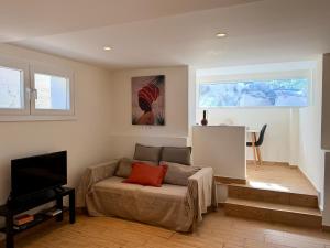 a living room with a couch and a flat screen tv at Marina in Aghia Marina