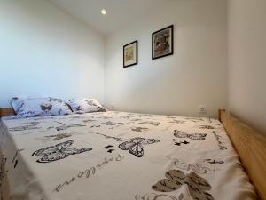 a bedroom with a bedspread with butterflies on it at Marina in Aghia Marina