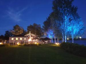 a house lit up at night with blue lights at Kraatterin Helmi Suite Resort Premium-Luxus 1107 in Lappajärvi