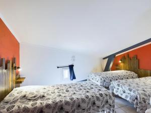 two beds in a room with orange walls at Gîtes de l'Esquirou in Lagorce +231 photos